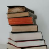 brown and red books on white surface
