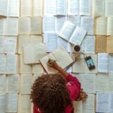 girl in pink shirt reading book